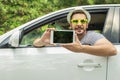 Car driver showing digital tablet with blank screen Royalty Free Stock Photo